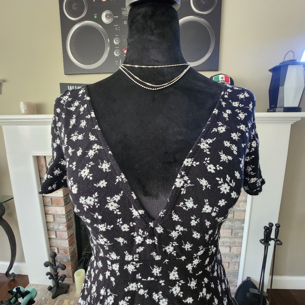 Black dress with flowers, neckline on the chest and back.  Size: Small